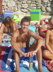 Topless wife with her family on the beach
