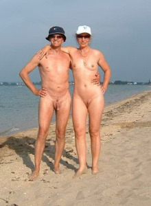 Nudists family at the beach