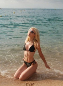 Sexy blonde gf in the sea in black bikini
