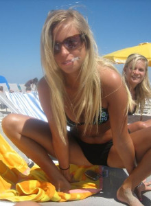 Girl in bikini smoking at the beach