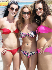 Laura and her tasty girlfriends in bikinis are playful on the beach