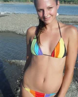 Beautiful fairy Josie is by the river wearing rainbow bikini