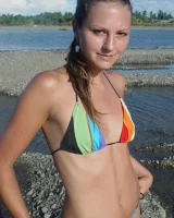 Beautiful fairy Josie is by the river wearing rainbow bikini