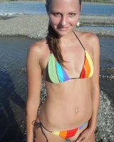 Beautiful fairy Josie is by the river wearing rainbow bikini