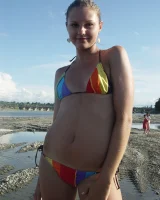 Beautiful fairy Josie is by the river wearing rainbow bikini