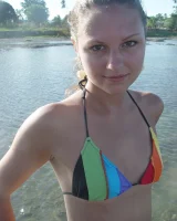 Beautiful fairy Josie is by the river wearing rainbow bikini