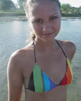 Beautiful fairy Josie is by the river wearing rainbow bikini