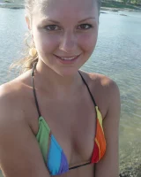 Beautiful fairy Josie is by the river wearing rainbow bikini