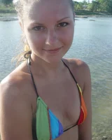 Beautiful fairy Josie is by the river wearing rainbow bikini