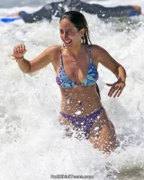 Candid surfer girl in bikini on the beach